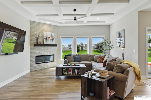 4803 N 192nd Ave, Elkhorn, NE 68022 - living area with ceiling fan, coffered ceiling, a fireplace, beam ceiling, and wood finished floors