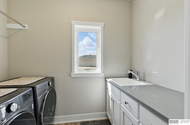 4803 N 192nd Ave, Elkhorn, NE 68022 - clothes washing area with washing machine and dryer, cabinet space, and baseboards