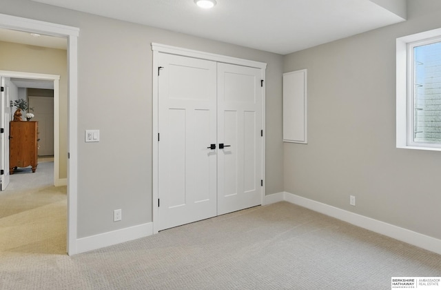 4803 N 192nd Ave, Elkhorn, NE 68022 - unfurnished bedroom with light carpet, baseboards, and a closet