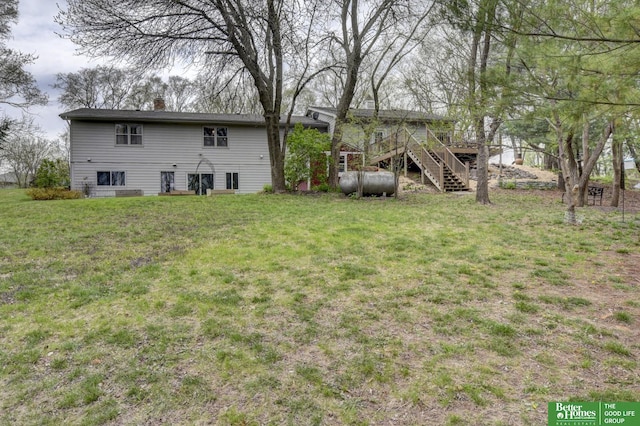 10032 Kings Dr, Omaha, NE 68142 - view of grassy yard with stairway and a wooden deck
