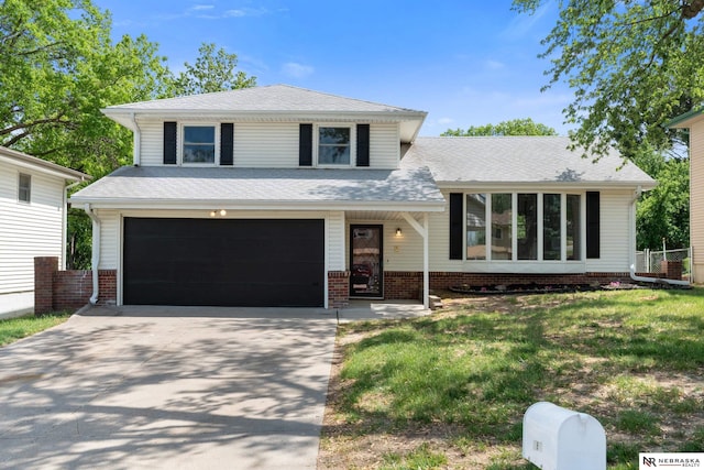 14611 Holmes St, Omaha, NE 68137 - tri-level home with a garage, concrete driveway, a front lawn, and roof with shingles