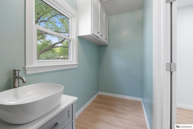 14611 Holmes St, Omaha, NE 68137 - bathroom featuring wood finished floors, vanity, and baseboards