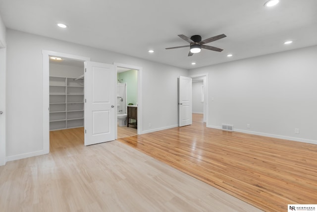 14611 Holmes St, Omaha, NE 68137 - unfurnished bedroom featuring a walk in closet, light wood-style flooring, recessed lighting, baseboards, and a closet