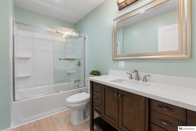 14611 Holmes St, Omaha, NE 68137 - bathroom with vanity, wood finished floors, toilet, and bath / shower combo with glass door
