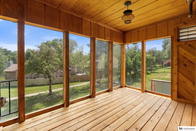 14611 Holmes St, Omaha, NE 68137 - unfurnished sunroom with wood ceiling, hardwood / wood-style flooring, a deck, and view of scattered trees