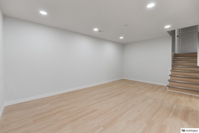 14611 Holmes St, Omaha, NE 68137 - below grade area featuring wood finished floors, stairs, baseboards, and recessed lighting