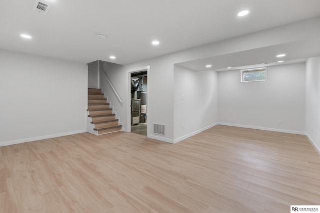 14611 Holmes St, Omaha, NE 68137 - basement featuring stairway, recessed lighting, baseboards, light wood-style floors, and gas water heater