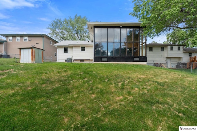 14611 Holmes St, Omaha, NE 68137 - back of house featuring cooling unit, a sunroom, a storage unit, and an outdoor structure