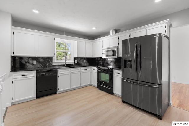 14611 Holmes St, Omaha, NE 68137 - kitchen featuring black appliances, a sink, dark countertops, white cabinets, and recessed lighting