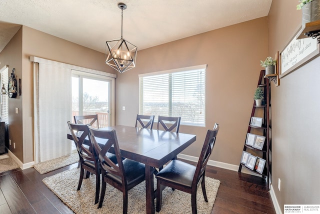 8902 N 161st Ave, Bennington, NE 68007 - dining area featuring dark wood finished floors, a chandelier, and baseboards