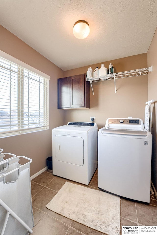 8902 N 161st Ave, Bennington, NE 68007 - laundry area with washing machine and clothes dryer, cabinet space, light tile patterned flooring, and baseboards