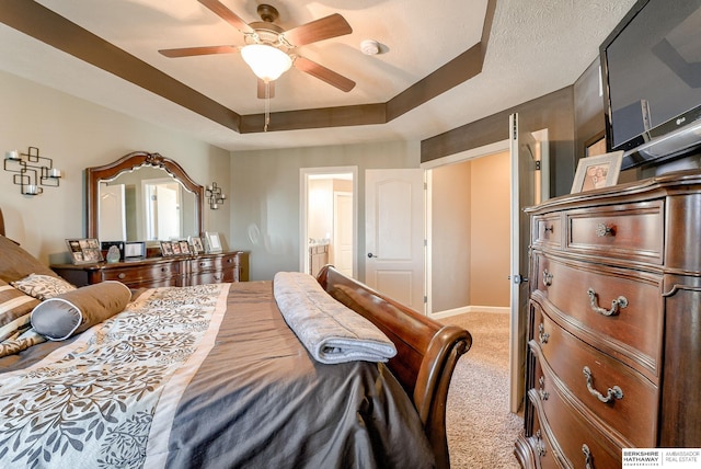 8902 N 161st Ave, Bennington, NE 68007 - bedroom with light colored carpet, a tray ceiling, connected bathroom, baseboards, and ceiling fan