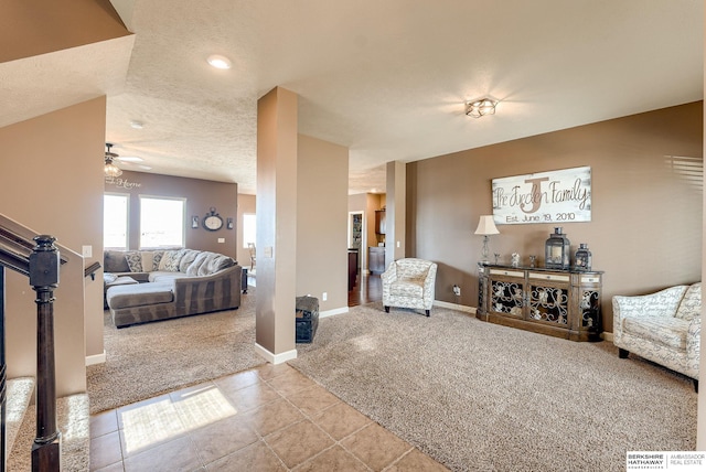 8902 N 161st Ave, Bennington, NE 68007 - living area with light carpet, ceiling fan, baseboards, light tile patterned flooring, and a textured ceiling