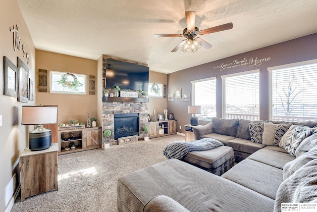8902 N 161st Ave, Bennington, NE 68007 - living area featuring carpet flooring, a textured ceiling, a ceiling fan, a fireplace, and baseboards