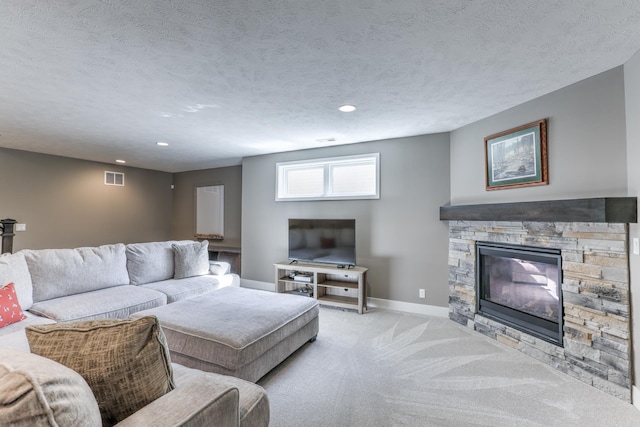 living room featuring carpet flooring, baseboards, a fireplace, recessed lighting, and a textured ceiling