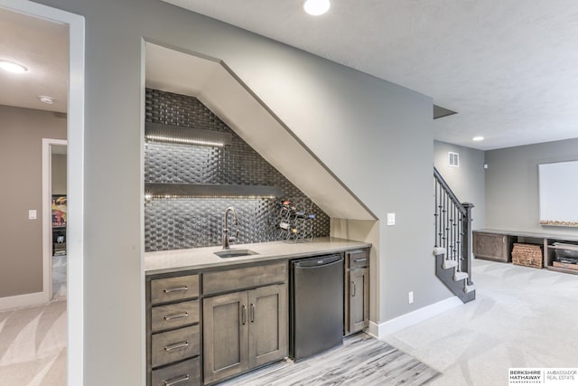 indoor wet bar with dishwasher, light colored carpet, stairs, backsplash, and recessed lighting