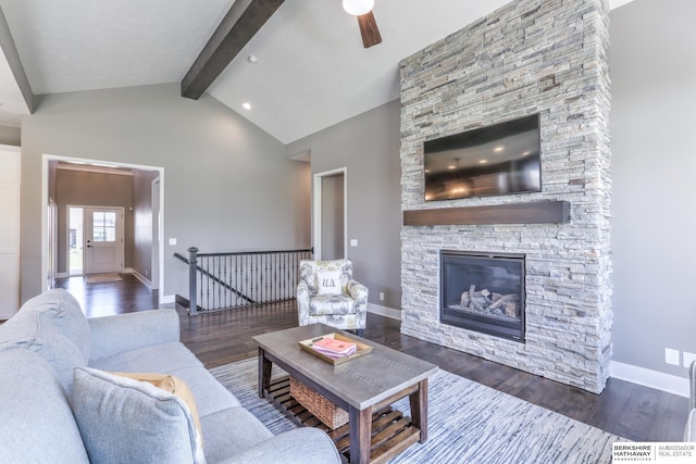 living room with beam ceiling, wood finished floors, ceiling fan, a fireplace, and baseboards