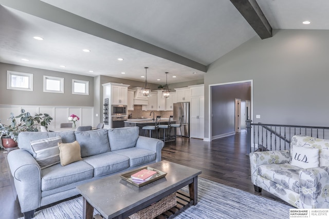 living room with dark wood finished floors and recessed lighting