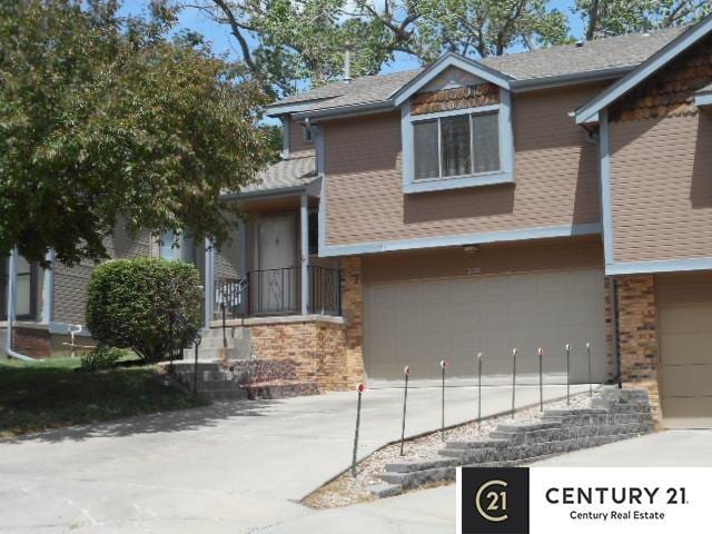 view of front facade featuring an attached garage, brick siding, and driveway