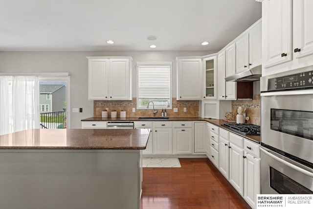8917 N 157th St, Bennington, NE 68007 - kitchen featuring under cabinet range hood, gas cooktop, a sink, double oven, and dark wood finished floors