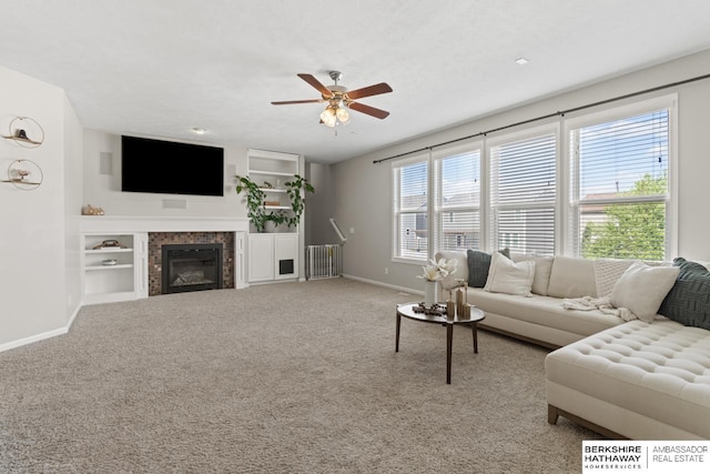 8917 N 157th St, Bennington, NE 68007 - living area featuring baseboards, a ceiling fan, carpet flooring, a fireplace, and built in shelves