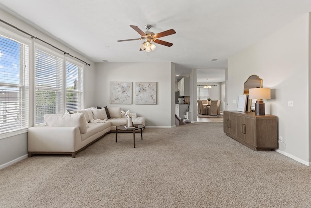 8917 N 157th St, Bennington, NE 68007 - carpeted living area with a ceiling fan, baseboards, healthy amount of natural light, and a chandelier