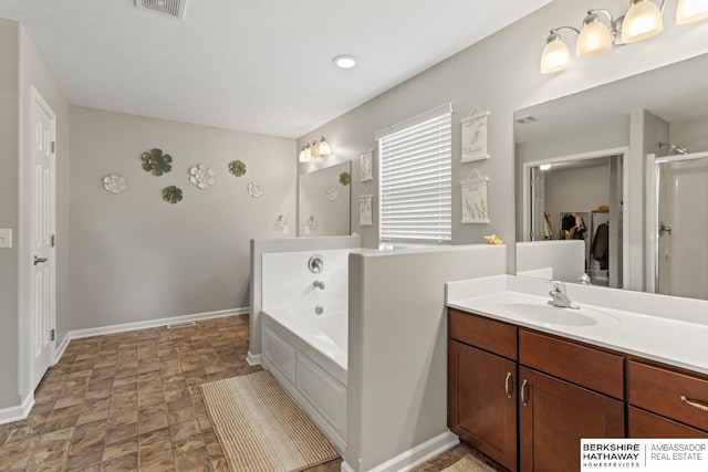 8917 N 157th St, Bennington, NE 68007 - bathroom featuring a garden tub, baseboards, vanity, stone finish floors, and a shower