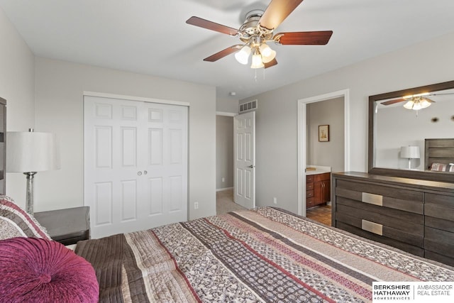 8917 N 157th St, Bennington, NE 68007 - carpeted bedroom featuring a closet, connected bathroom, and a ceiling fan