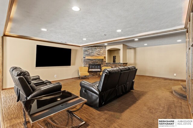 8917 N 157th St, Bennington, NE 68007 - carpeted cinema featuring a stone fireplace, recessed lighting, a textured ceiling, and baseboards