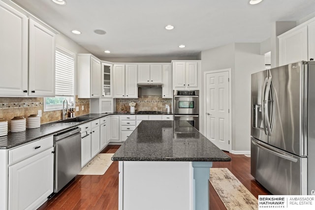 8917 N 157th St, Bennington, NE 68007 - kitchen with appliances with stainless steel finishes, a sink, a kitchen island, dark wood-type flooring, and recessed lighting