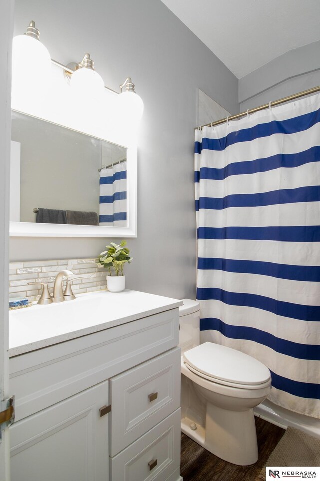467 Steinway Rd, Lincoln, NE 68505 - bathroom with toilet, wood finished floors, vanity, and a shower with curtain
