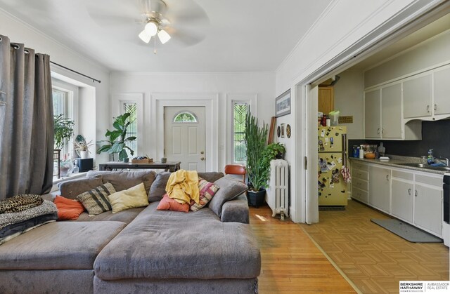 401 S 38th Ave, Omaha, NE 68131 - living room featuring radiator, ceiling fan, and ornamental molding