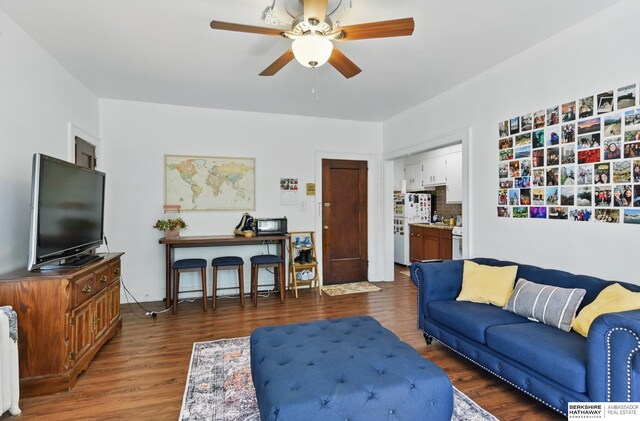 401 S 38th Ave, Omaha, NE 68131 - living area featuring wood finished floors, a ceiling fan, and radiator heating unit