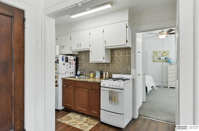 401 S 38th Ave, Omaha, NE 68131 - kitchen with white appliances, a sink, a ceiling fan, backsplash, and dark wood-type flooring