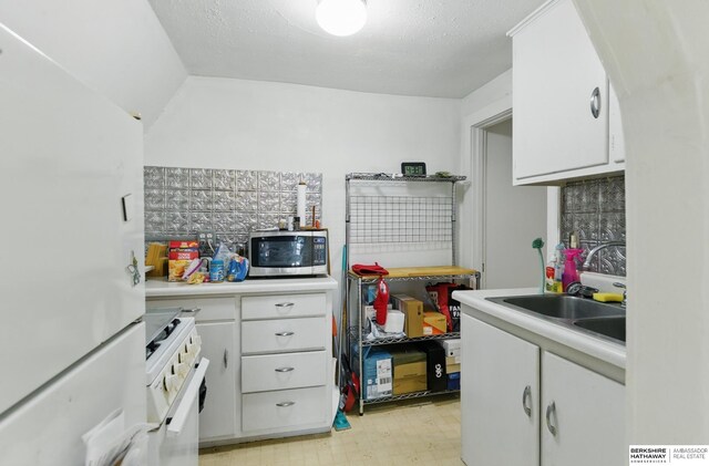 401 S 38th Ave, Omaha, NE 68131 - kitchen featuring white appliances, light countertops, white cabinetry, a sink, and light flooring