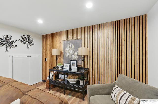 living area featuring wood finished floors, recessed lighting, and wooden walls