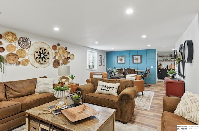 living room with light wood-style floors and recessed lighting