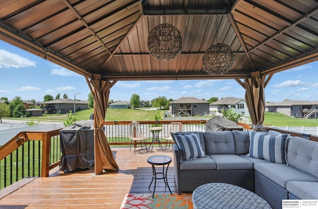 deck with a gazebo, an outdoor hangout area, and a residential view