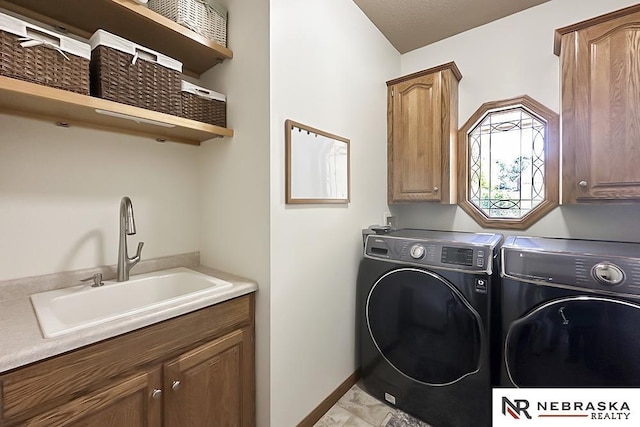 washroom featuring cabinet space, washing machine and dryer, and baseboards
