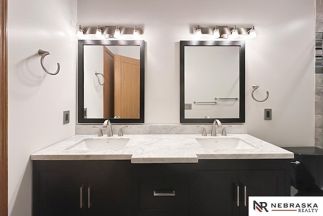 bathroom featuring double vanity and toilet