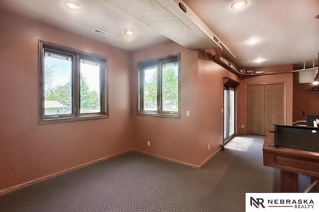 carpeted empty room with baseboards and recessed lighting