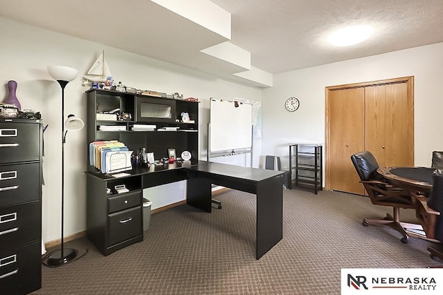 office featuring dark carpet and baseboards