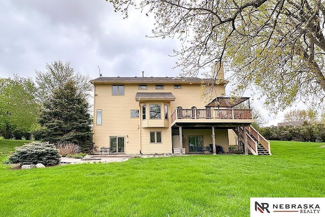 back of property with stairs, a deck, a lawn, and a patio area