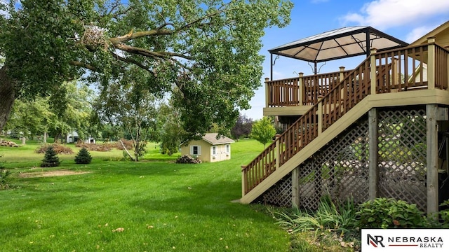 view of green lawn with a gazebo and stairs