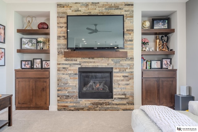 6707 S 209th St, Omaha, NE 68022 - living area with carpet floors, a ceiling fan, a stone fireplace, and built in features