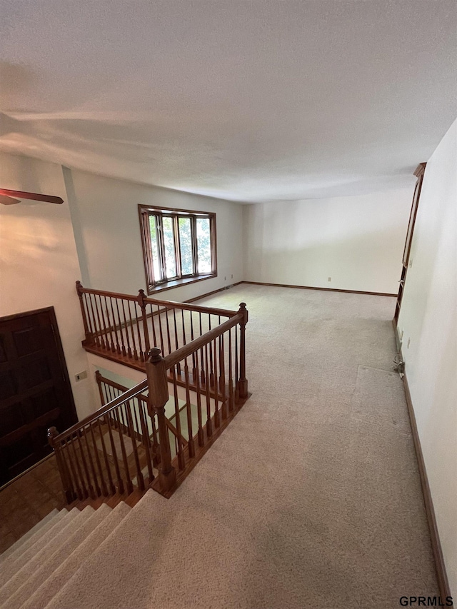 empty room with carpet and baseboards