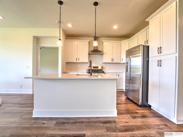 kitchen with stainless steel fridge, a sink, wall chimney exhaust hood, white cabinets, and light countertops