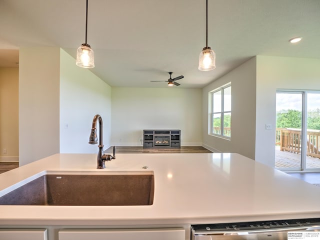 kitchen featuring a sink, ceiling fan, pendant lighting, open floor plan, and recessed lighting