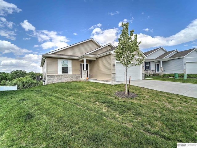 view of front of property with stone siding, driveway, and a garage