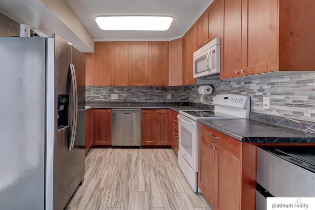 13253 Josephine St, Omaha, NE 68138 - kitchen with stainless steel appliances, dark countertops, brown cabinetry, and backsplash